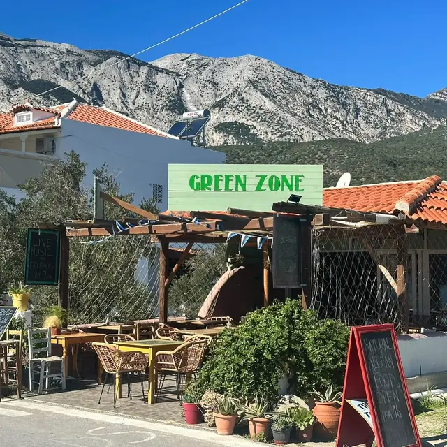 The Green Zone terrace under its green sign, with the mountains of Samos behind